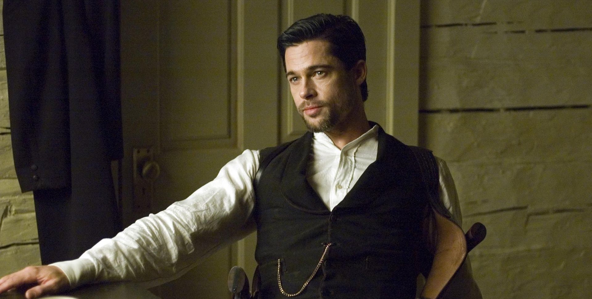 Brad Pitt sitting in field in The Assassination of Jesse James by the Coward Robert Ford (2007)