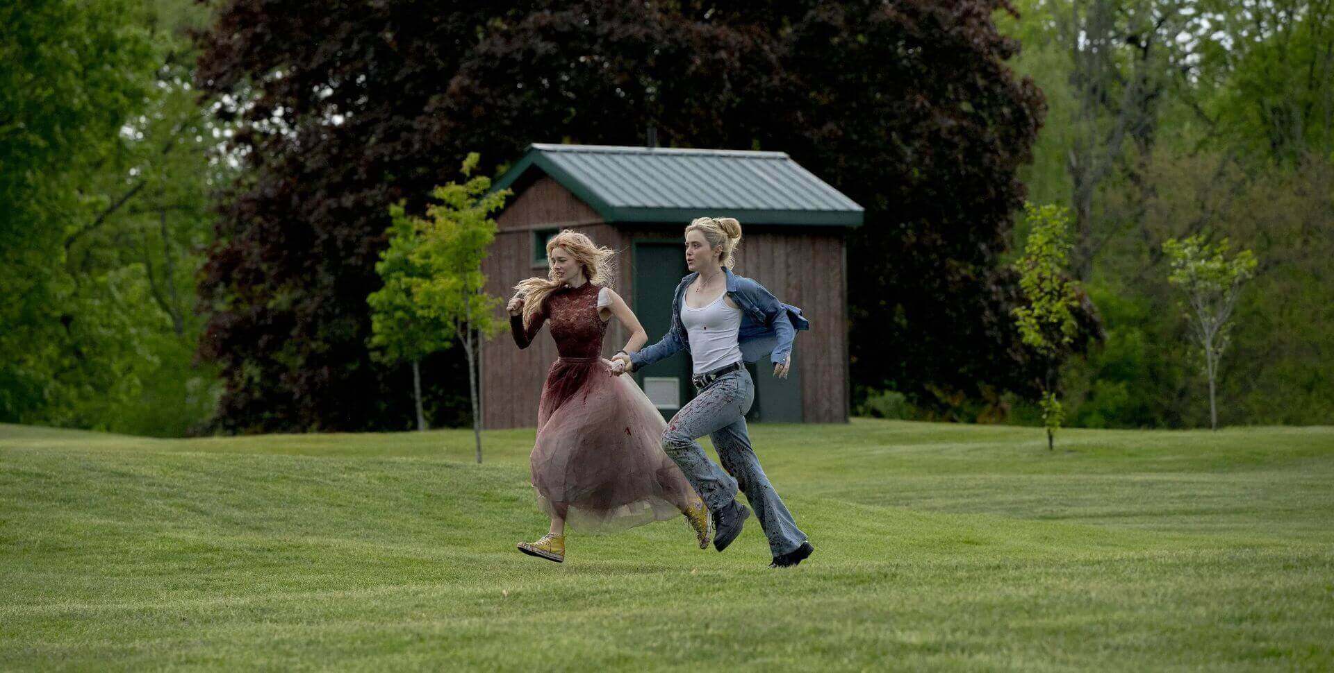 Still of Samara Weaving and Kathryn Newton running down a field in Ready or Not 2: Here I Come (2026)
